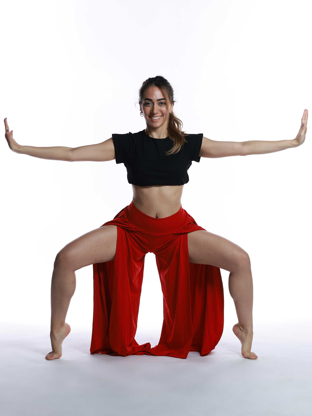 Danseuse en movimiento con pantalón de danse rojo – look expressif y ample.